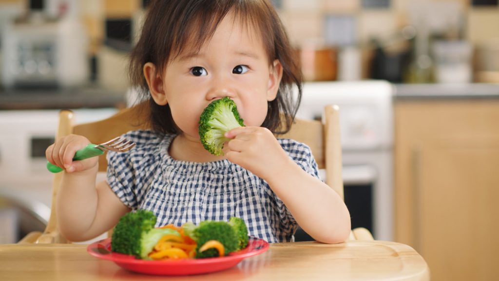 child eating vegetables